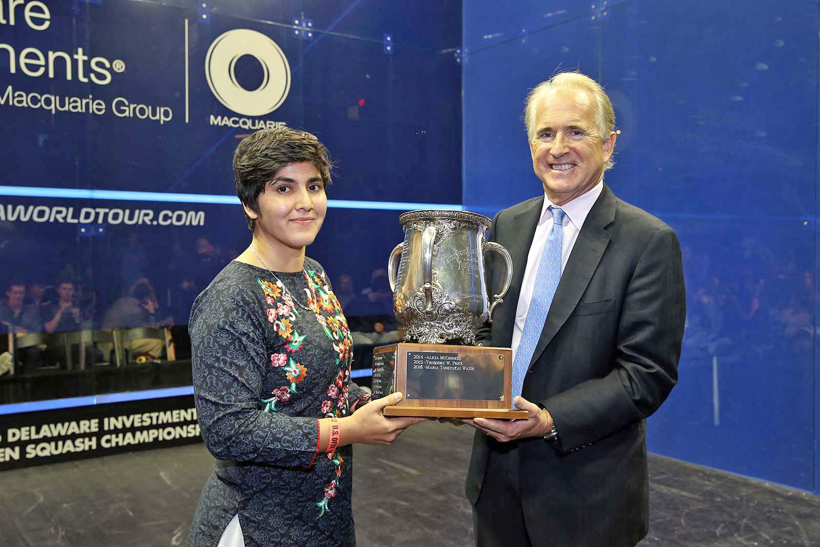 US Squash Chairman of the Board Mark Pagon (r) presents Maria Toorpakai with the US Squash President's Cup.